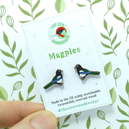 Wooden magpie stud earrings on display card