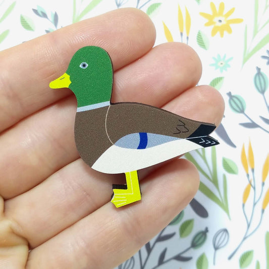 Wooden mallard pin badge held on hand