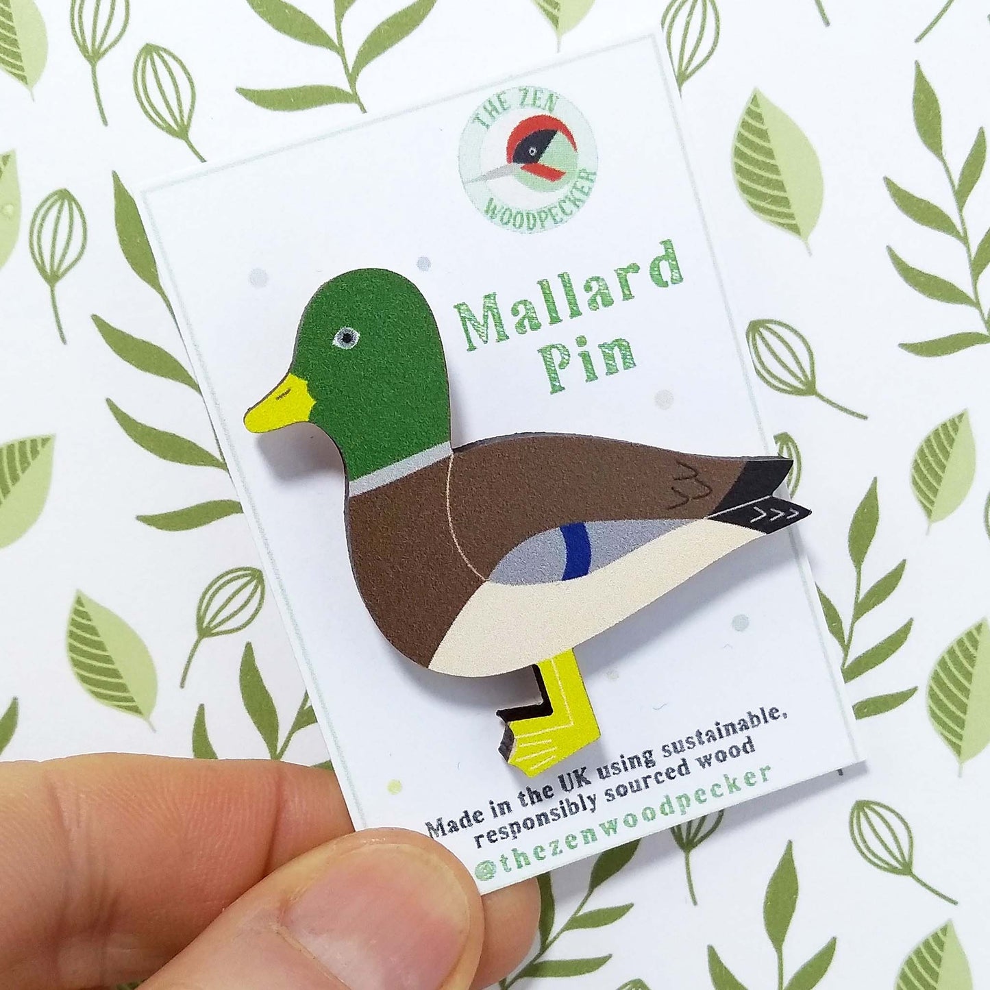 Wooden mallard pin badge on display card