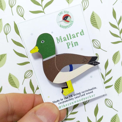 Wooden mallard pin badge on display card