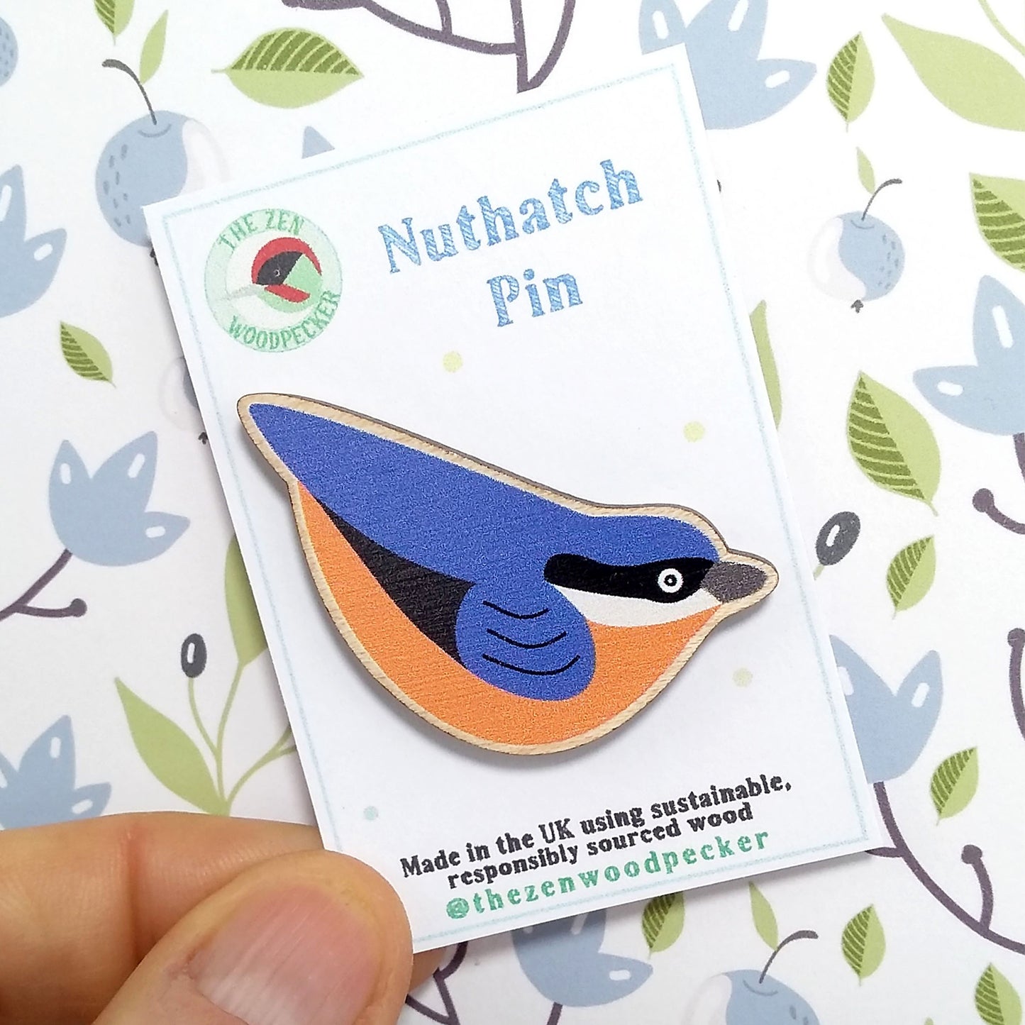 Wooden nuthatch pin badge on display card