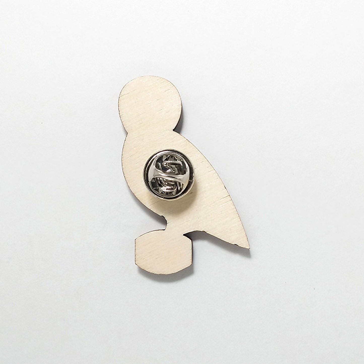 Back of owl pin badge showing metal butterfly clutch pin