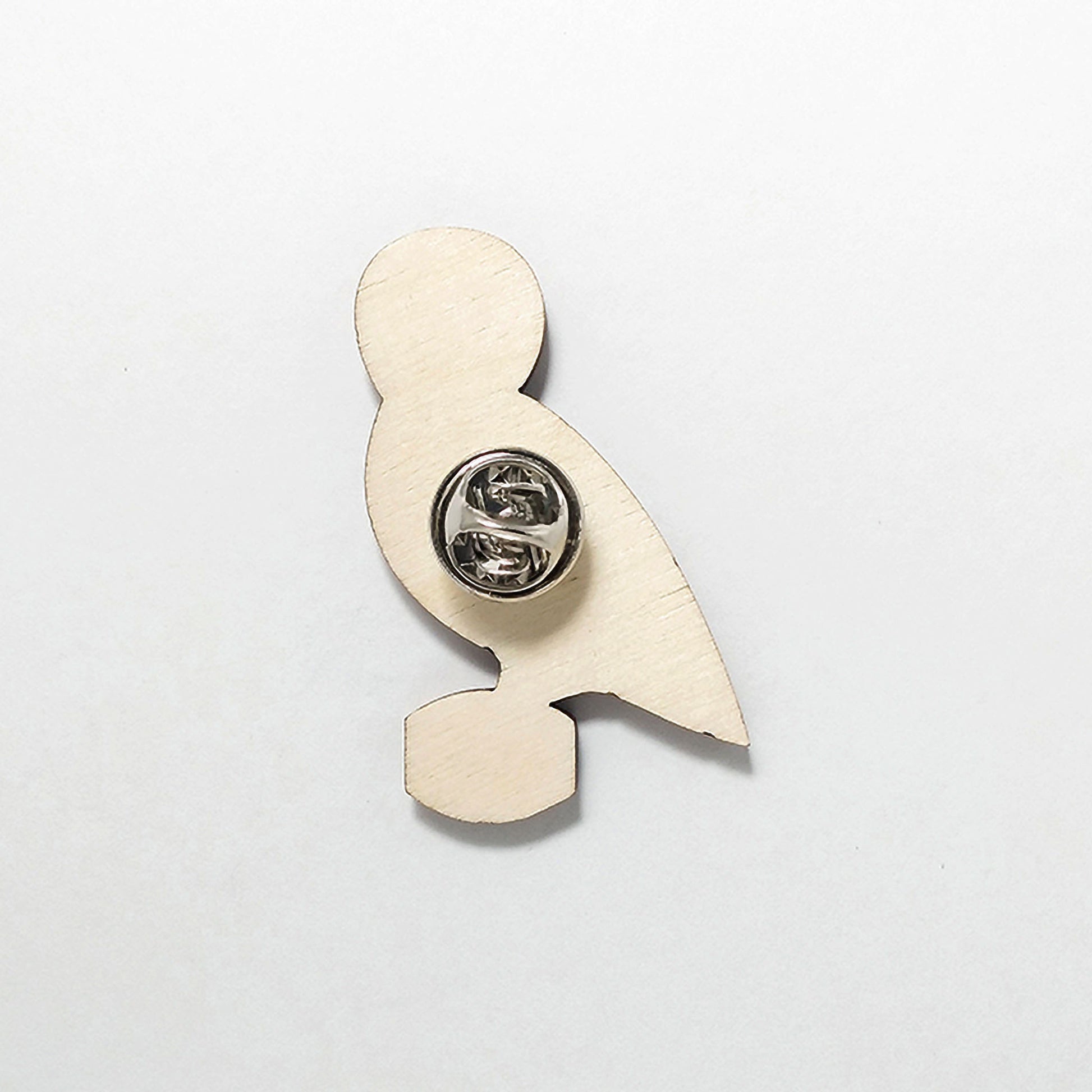 Back of owl pin badge showing metal butterfly clutch pin