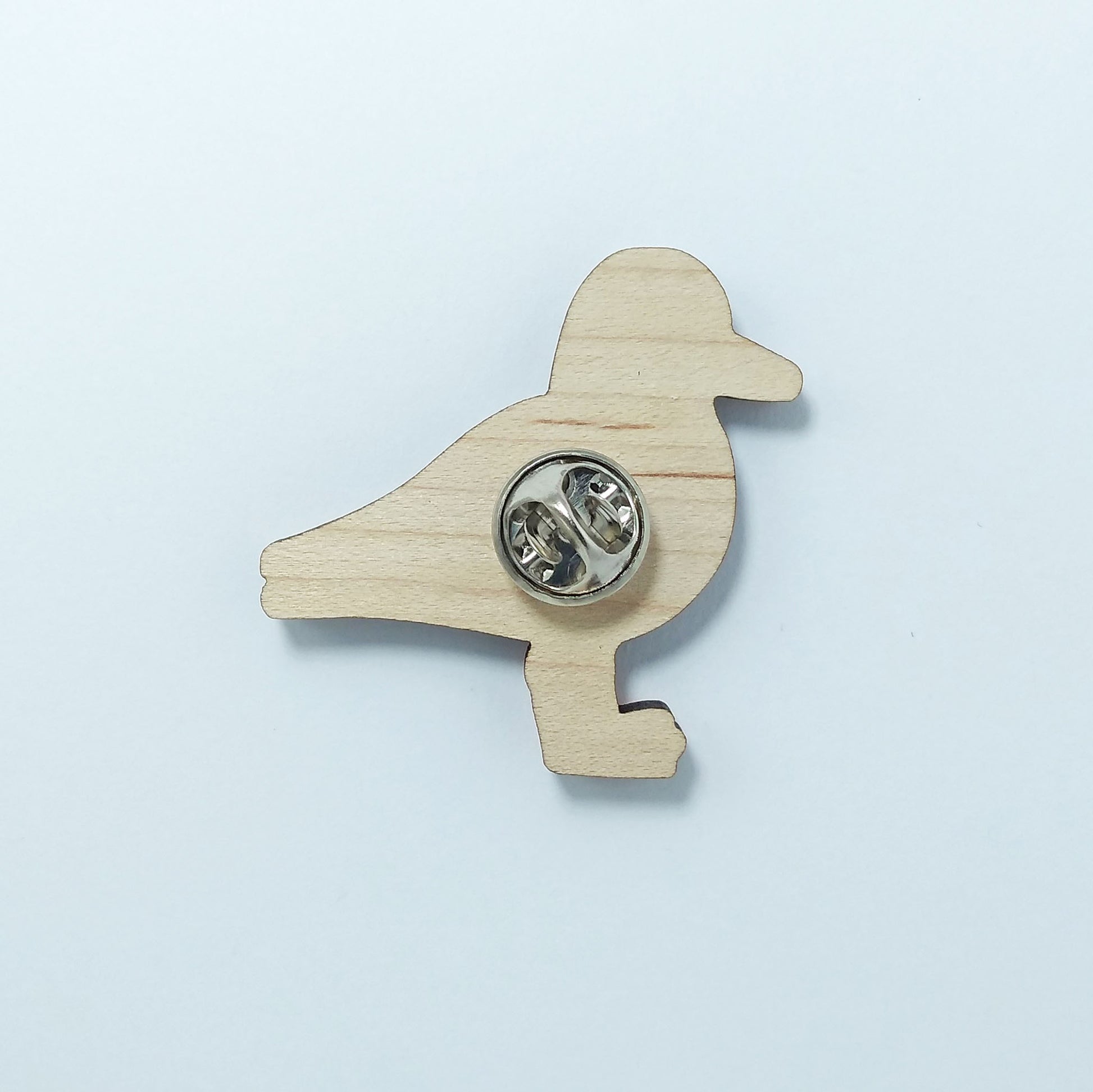 Back of oystercatcher pin badge showing metal butterfly clutch pin