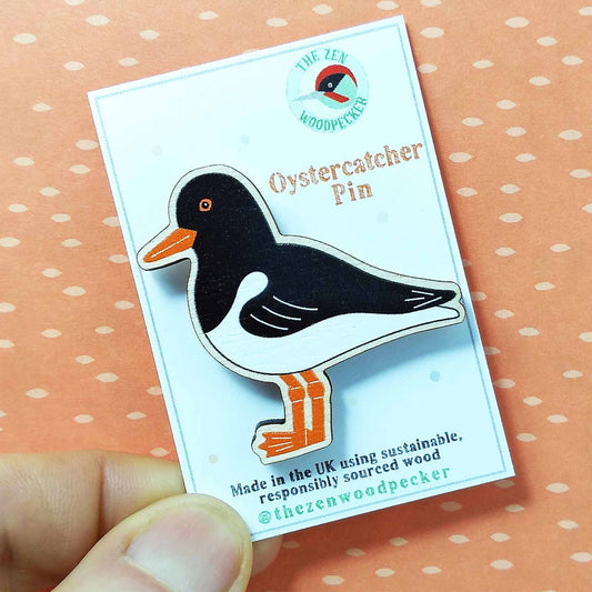 Wooden oystercatcher pin badge on display card