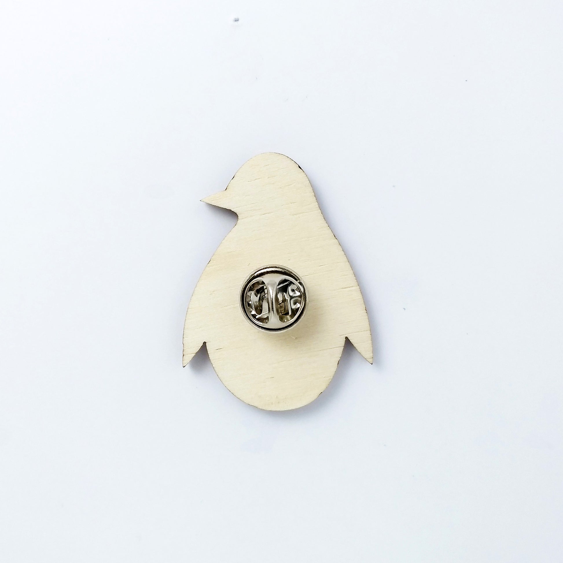 Back of penguin pin badge showing metal butterfly clutch pin