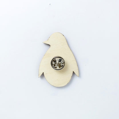 Back of penguin pin badge showing metal butterfly clutch pin