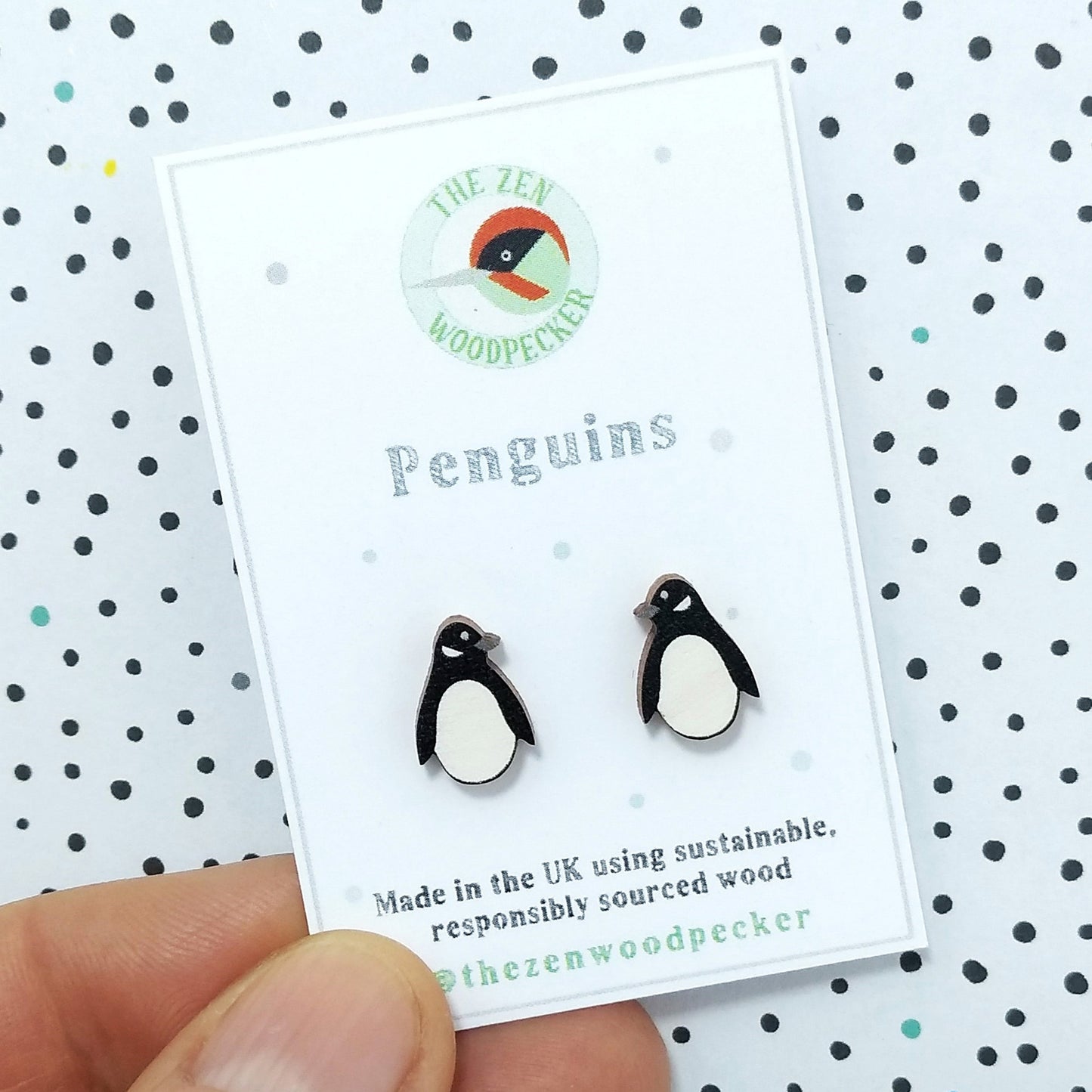 Wooden penguin stud earrings on display card