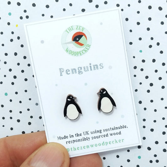 Wooden penguin stud earrings on display card