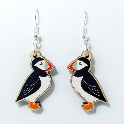 Wooden puffin dangle earrings on white background 