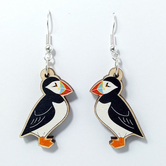 Wooden puffin dangle earrings on white background 