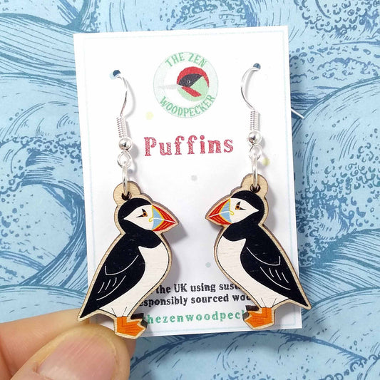 Wooden dangly puffin earrings on display card