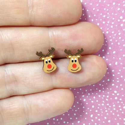 Reindeer wooden stud earrings held on hand