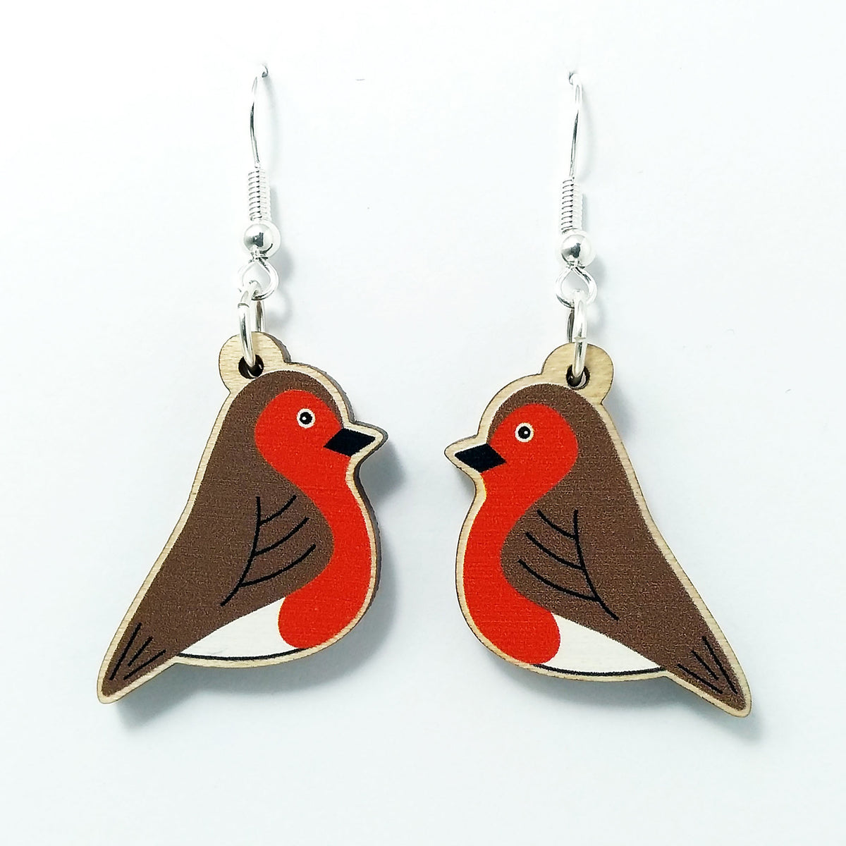 Wooden robin dangle earrings on white background 