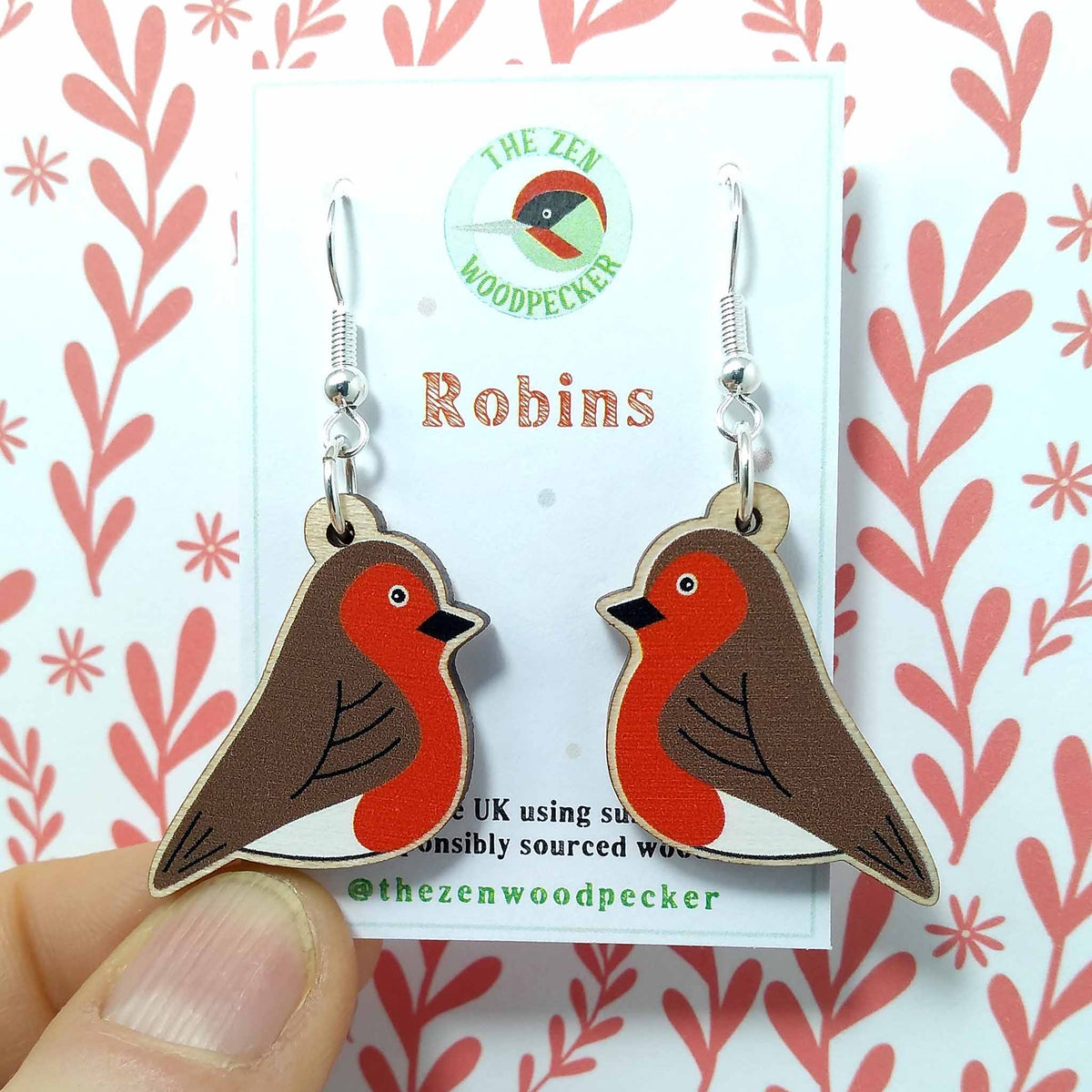 Wooden dangly robin earrings on display card
