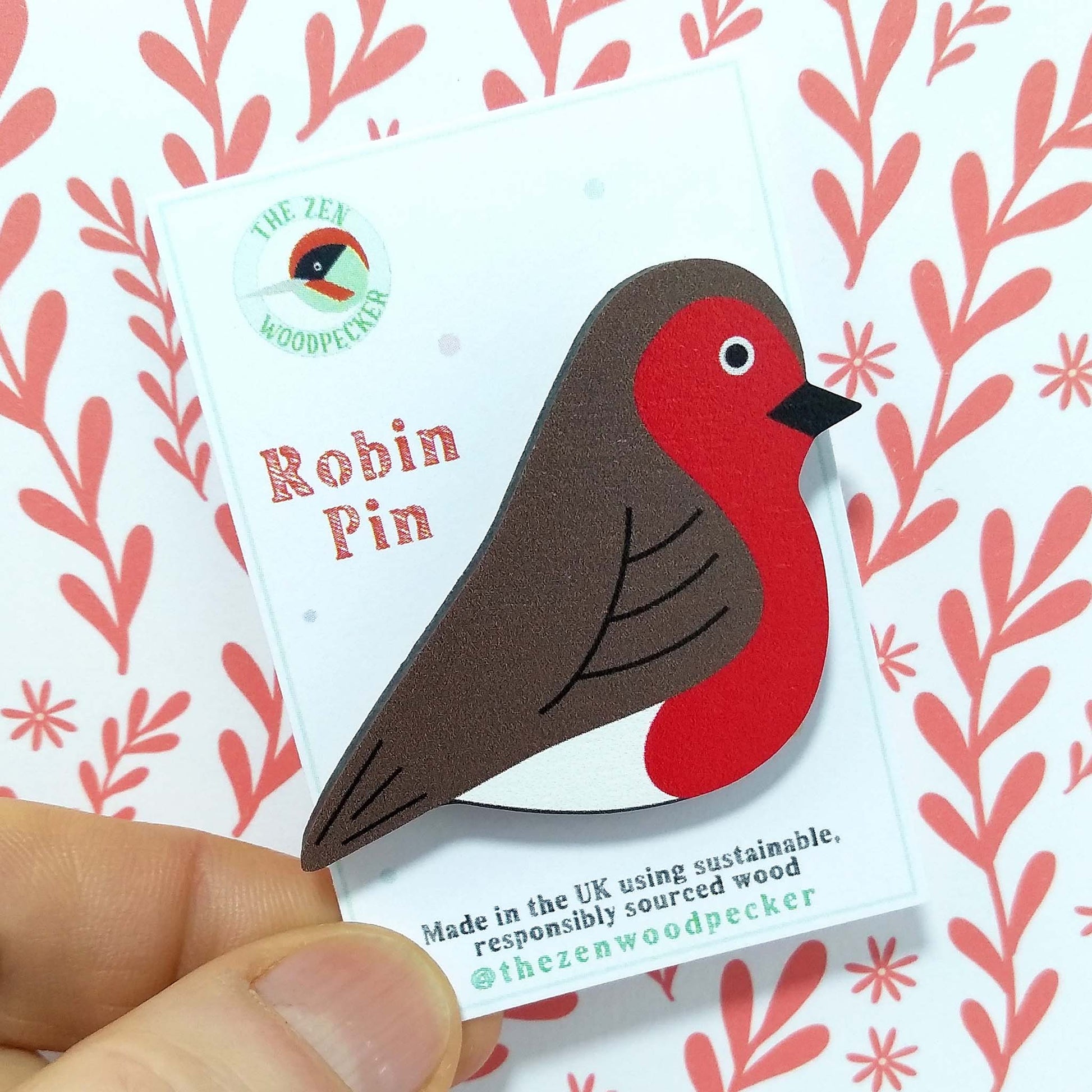 Wooden robin pin badge on display card