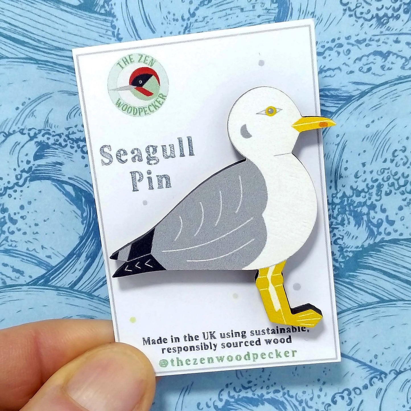 Wooden seagull pin badge on display card
