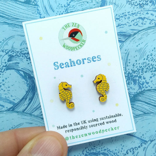 Wooden seahorse stud earrings on display card