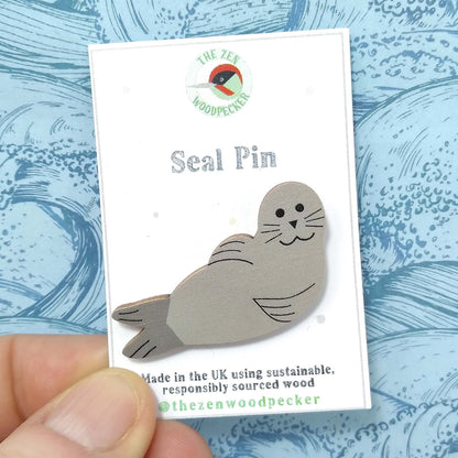Wooden seal pin badge on display card