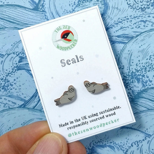 Wooden seal stud earrings on display card