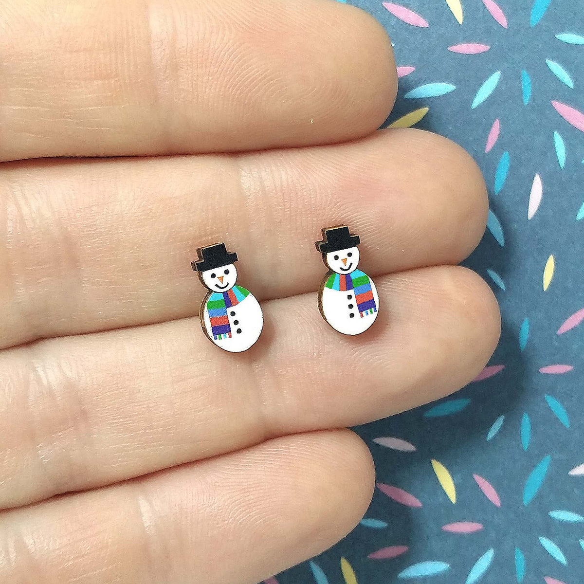 Snowman wooden stud earrings held on hand