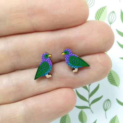 Wooden starling stud earrings held on hand