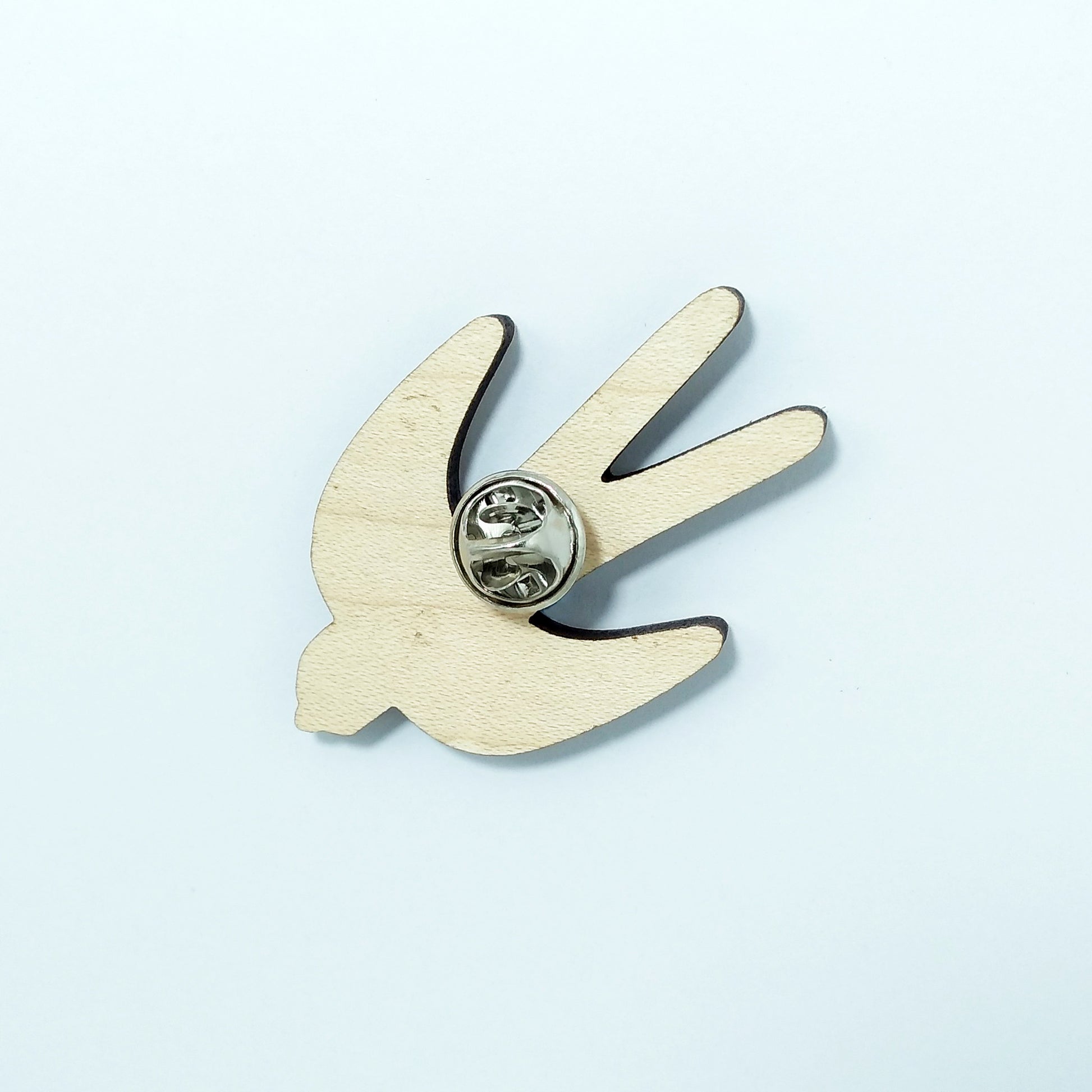 Back of swallow pin badge showing metal butterfly clutch pin