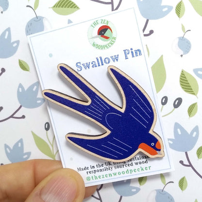 Wooden swallow pin badge on display card