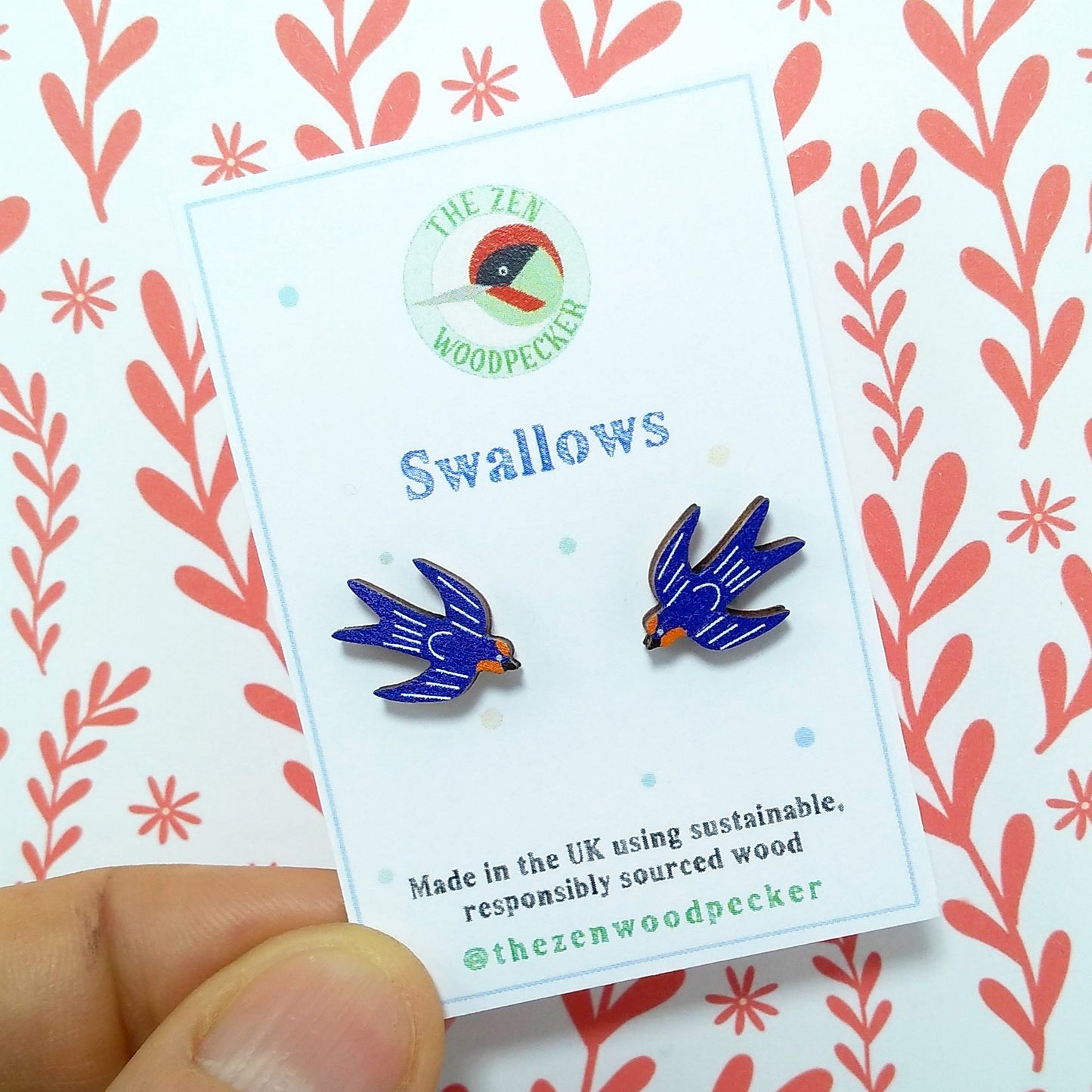 Wooden swallow stud earrings on display card