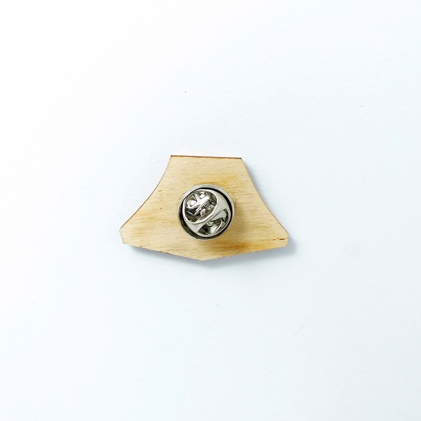 Back of yellow tent pin badge showing metal butterfly clutch pin