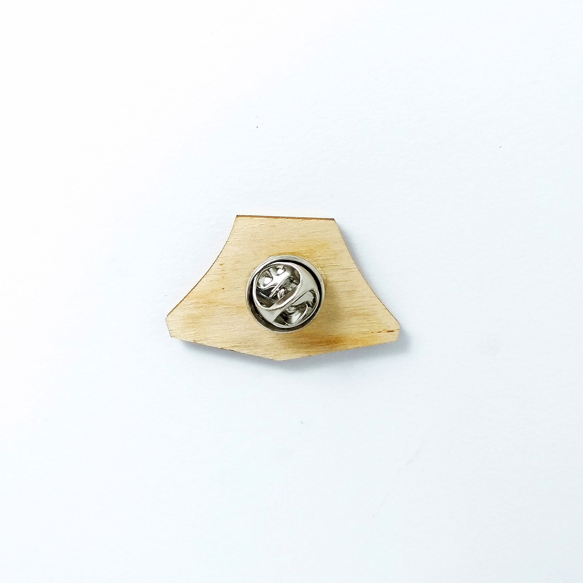 Back of yellow tent pin badge showing metal butterfly clutch pin