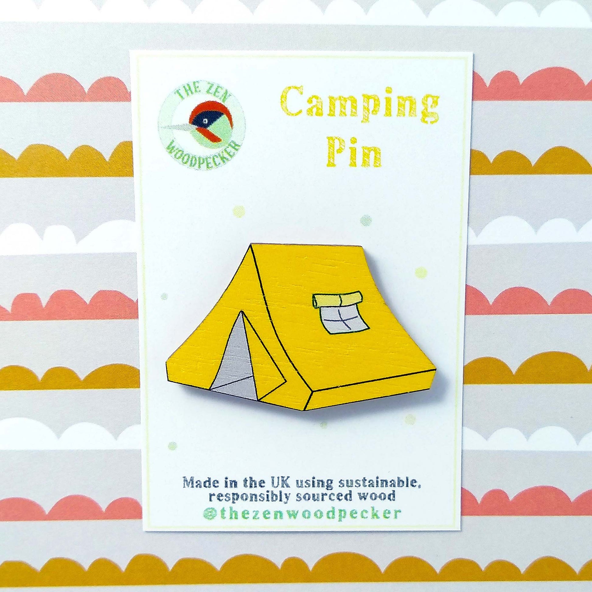 Wooden yellow tent pin badge on display card