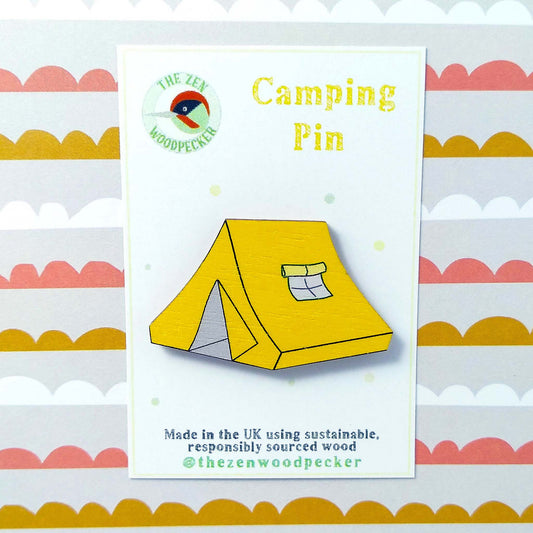Wooden yellow tent pin badge on display card