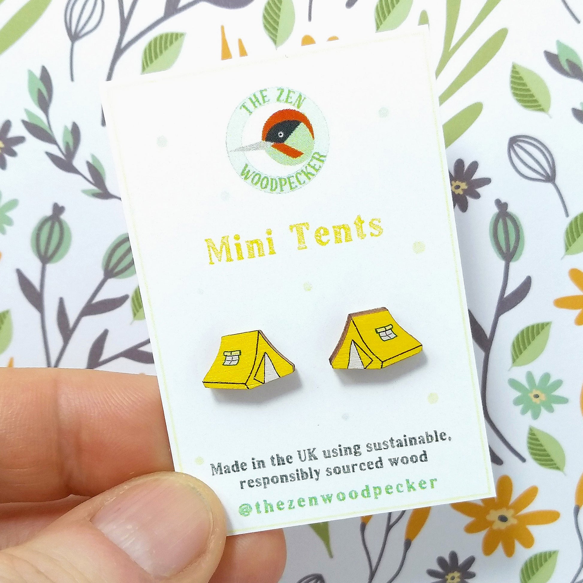 Wooden yellow tent stud earrings on display card