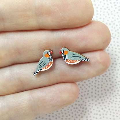Wooden zebra finch stud earrings held on hand